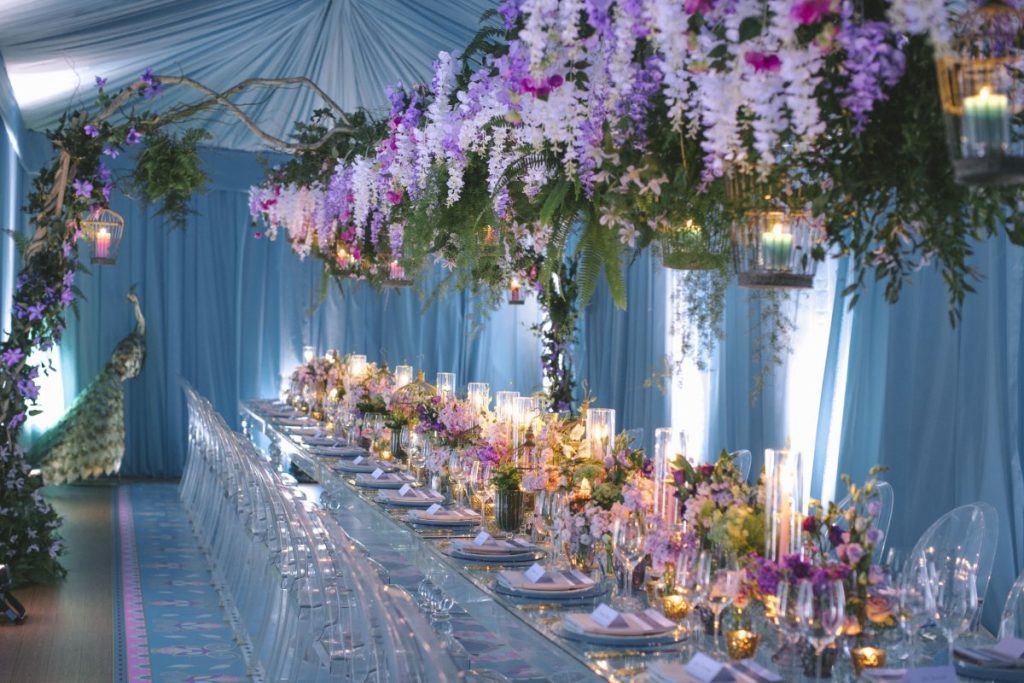 Floral dining table with flowers draped overtop inside tent created by CANDICE&ALISON