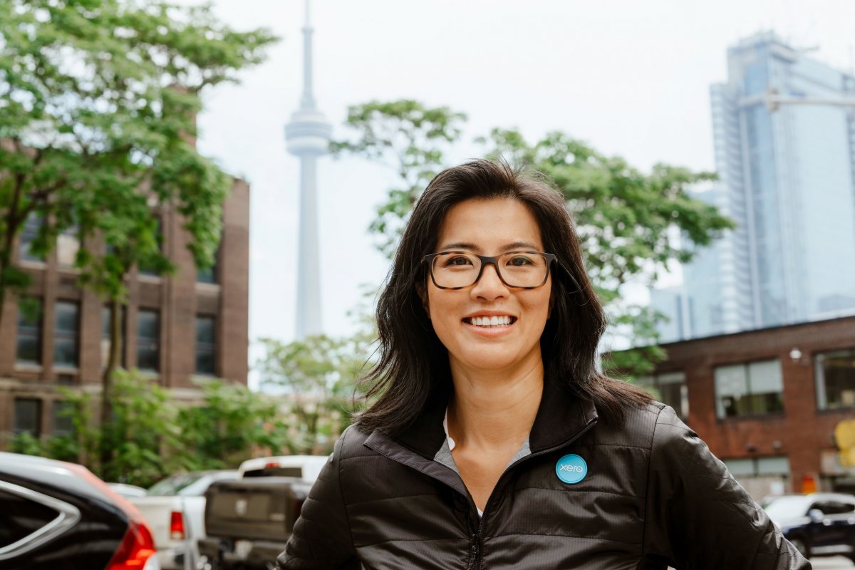 Faye Pang in black jacket with CN tower in background