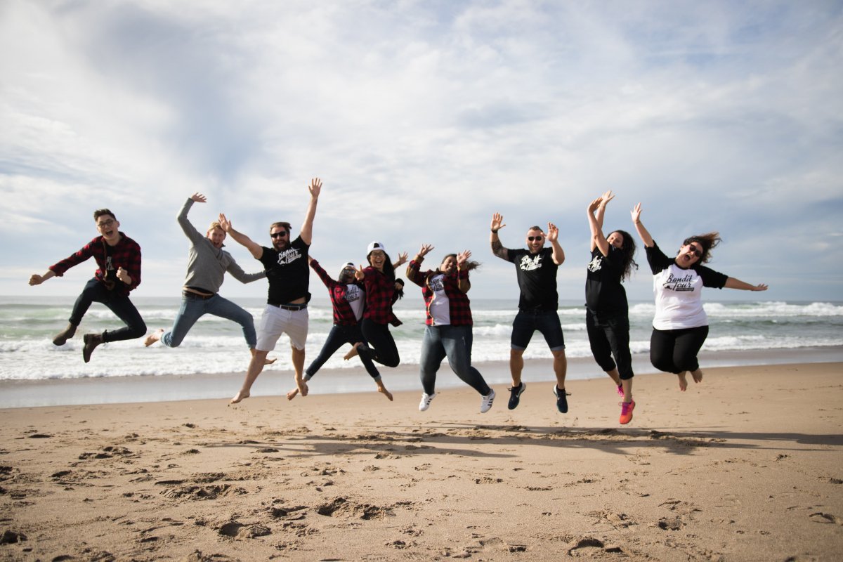 The Traction on Demand team posing on the beach.