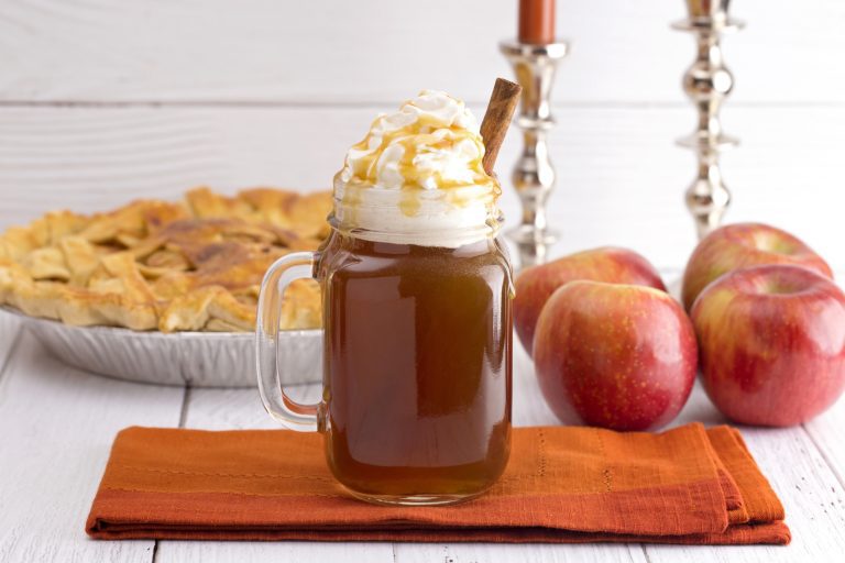 Hot Caramel Apple Cider with an Apple Pie and Cinnamon Stick