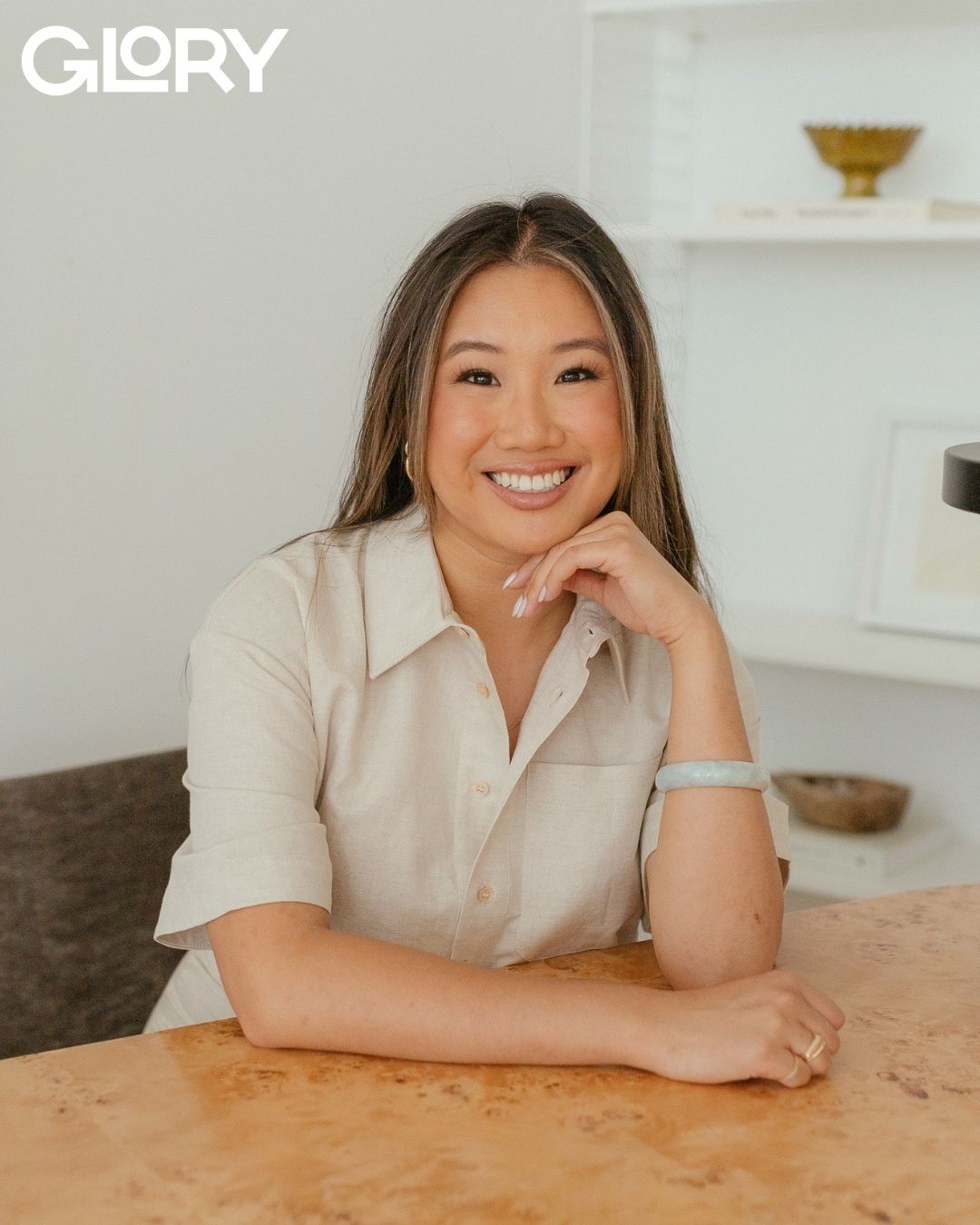 Madelyn Chung sitting at a table and smiling into the camera.