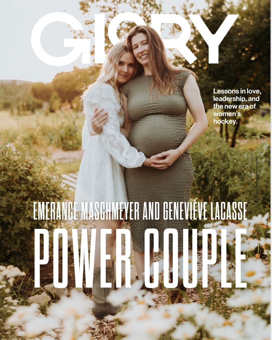 Emerance Maschmeyer and Genevieve Lacasse in an embrace holding Genevieve's pregnant belly against a wilderness backdrop.