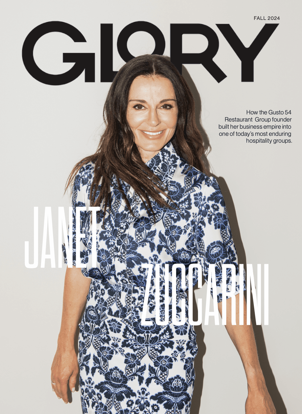 Janet Zuccarini in a white and blue dress on the cover of GLORY Magazine.